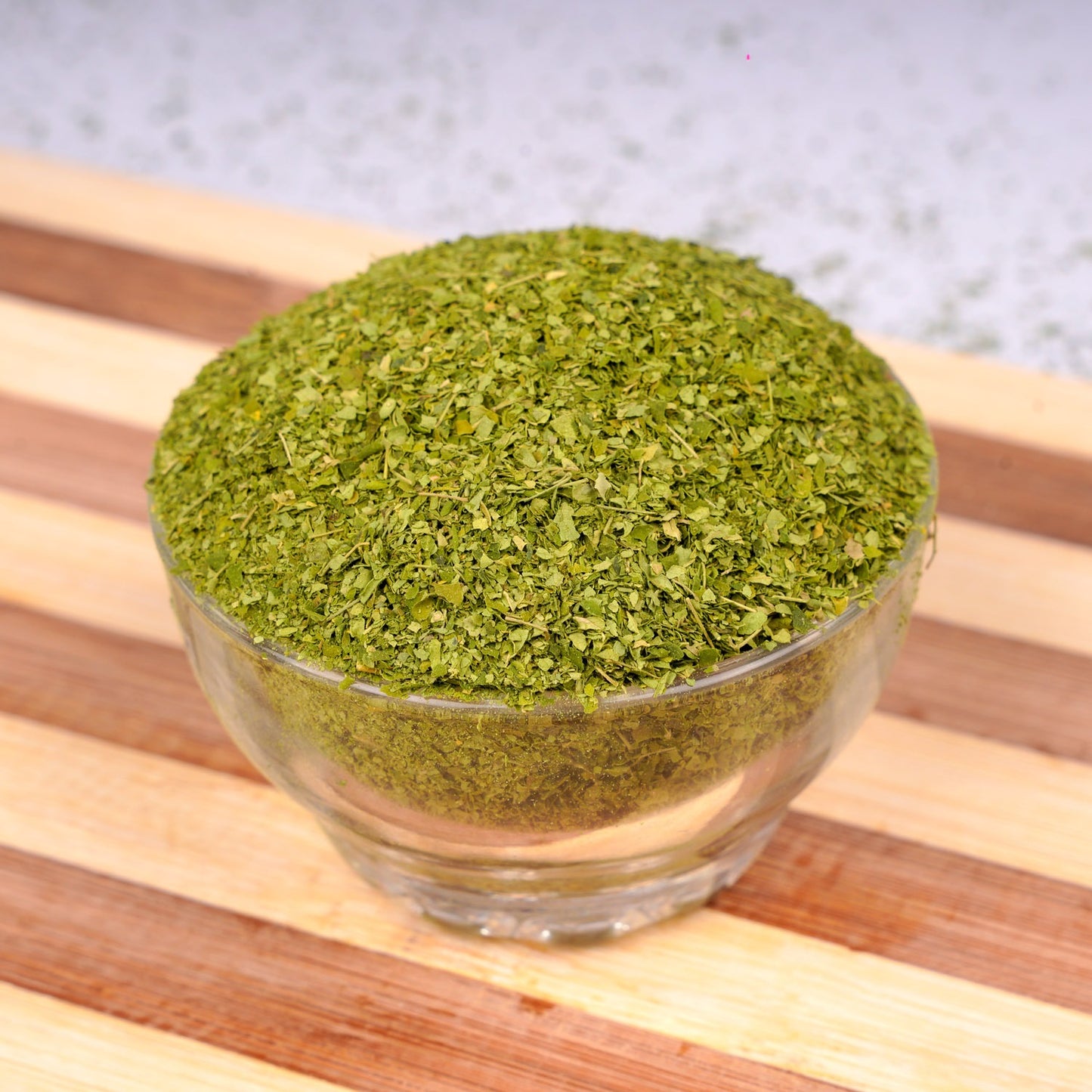 Close-up highlighting vibrant green dried moringa texture