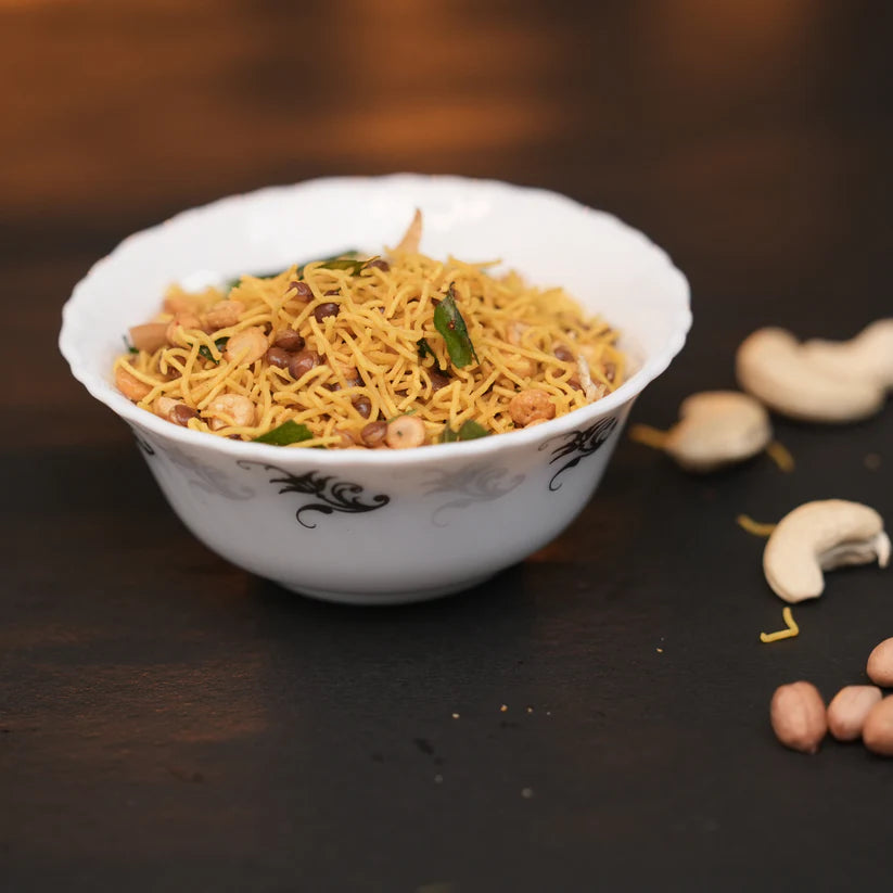 Close-up of crispy aval mixture with roasted peanuts and curry leaves