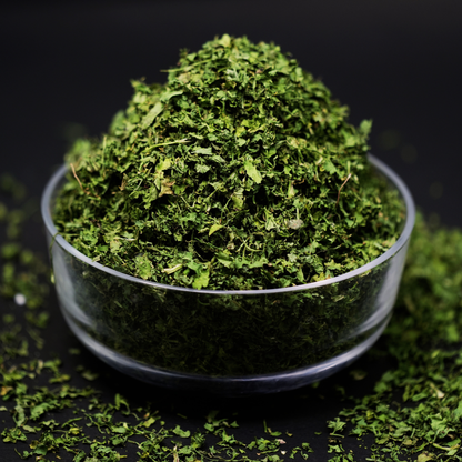 Close-up of solar dried coriander leaves showing vibrant green colour and fresh texture