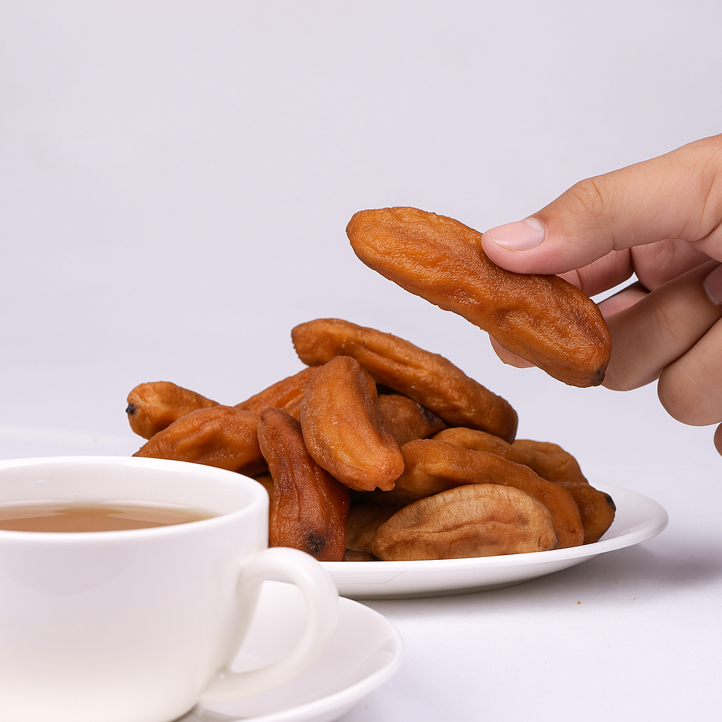 Hand holding a single dried banana slice to show actual size
