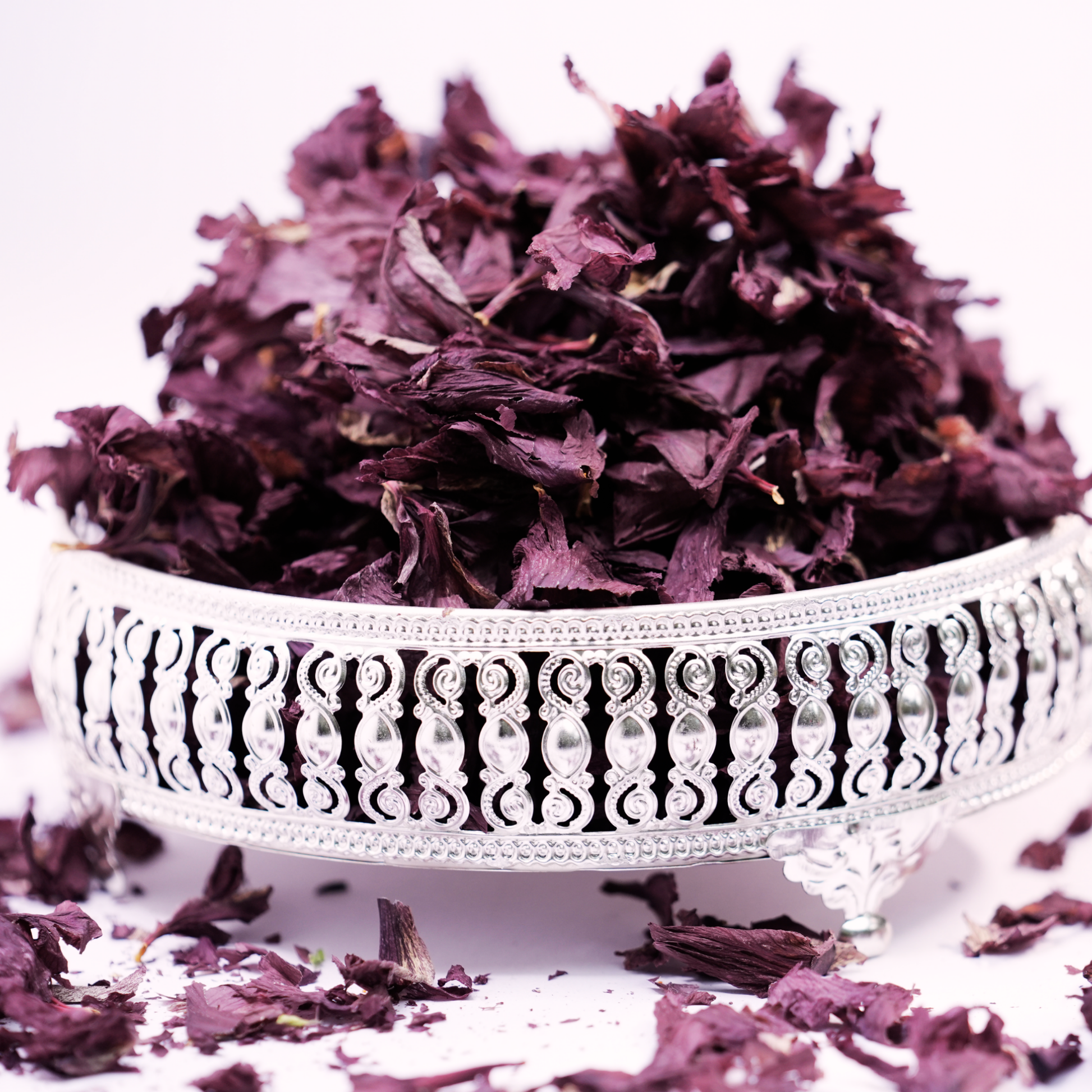 Solar dried hibiscus flowers steeping in hot water with lemon and honey as a wellness herbal tea