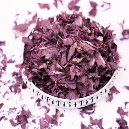 Brewed hibiscus flower water used as a natural nourishing hair rinse for scalp health and shine