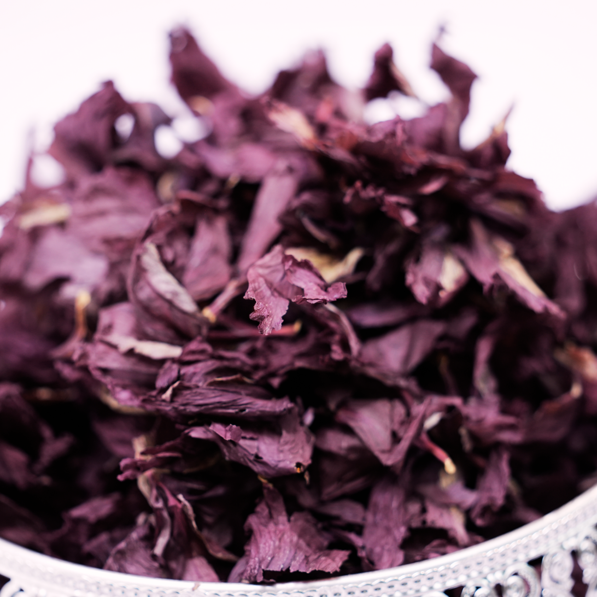 Close-up of solar dried hibiscus petals showing bold crimson colour and full bloom texture