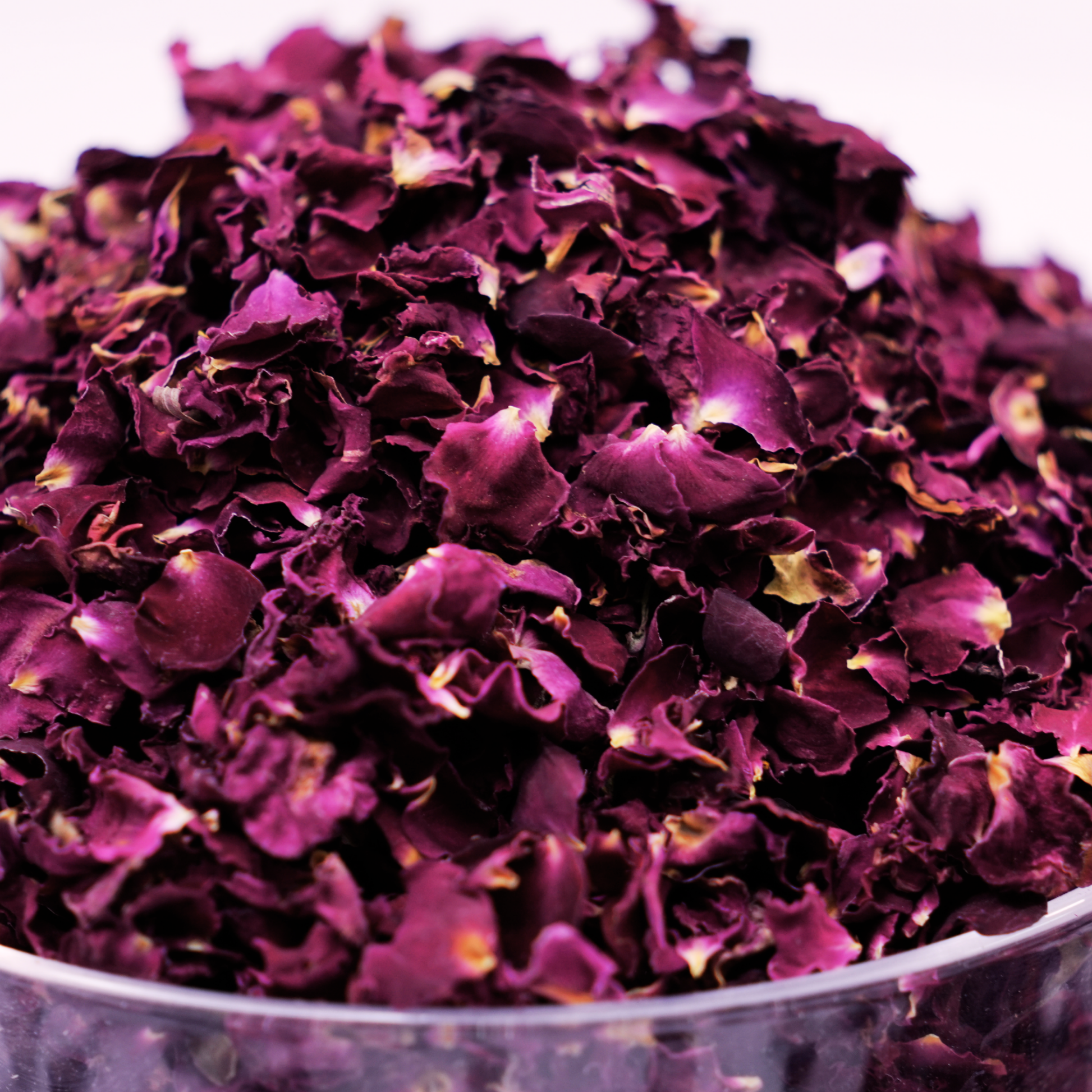 Solar dried rose petals steeping in hot water with honey and cardamom as a luxury floral tea